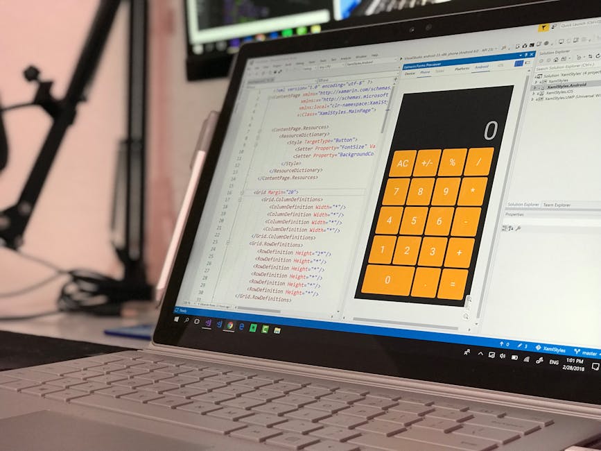 A close-up view of a laptop screen displaying a code editor with HTML and CSS code on the left side and a large, bright orange calculator interface on the right side. The code includes style definitio